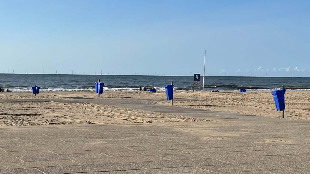 Strand. Uitzicht op het strand. Op de voorgrond de betonnen platen en het uitkijk plateau. 